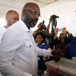George Weah, former soccer player and presidential candidate of Congress for Democratic Change (CDC), votes at a polling station in Monrovia